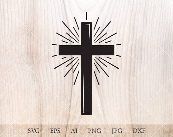 Black Christian cross icon with radiating light rays on light wooden background
